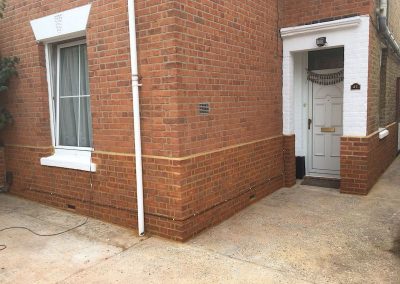 Door Surround re-painted & new Brick Plinth
